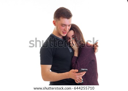 handsome guy with his cute girl watching and laughing phone