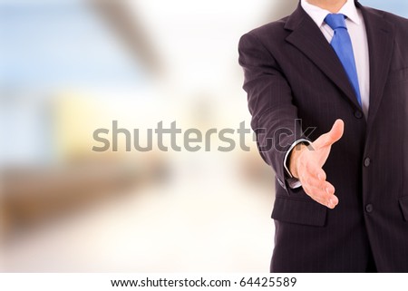 A businessman with an open hand ready to seal a deal at the office