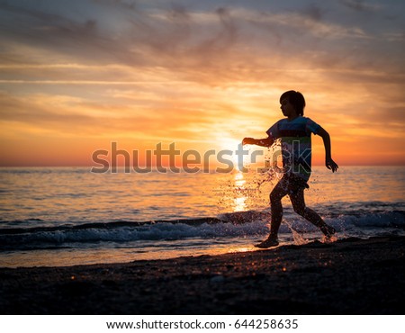 Happy boy enjoying the beach