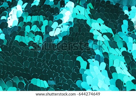 Spangle, sequin pailette background. Mirror dress material cloth texture pattern. Tailoring stitching concept. Shiny mirrored fashion fabric. Shiny clothing material sample. Creased fabric.
