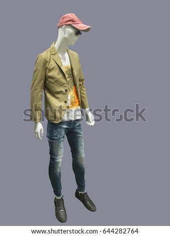 Full-length male mannequin dressed in jacket and blue ripped jeans, isolated on gray background. No brand names or copyright objects.