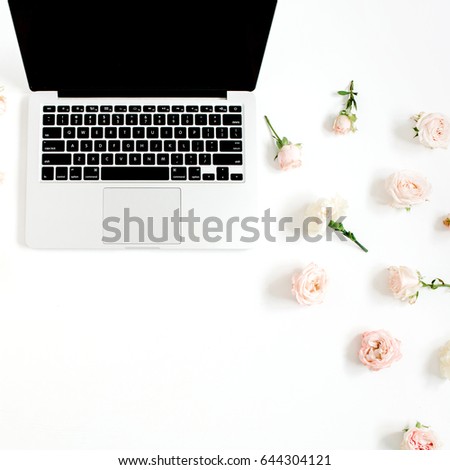 Laptop and flowers pattern made of beige rose buds on white background. Flat lay, top view. Floral background.