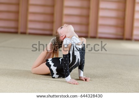 Young girl doing gymnastics.