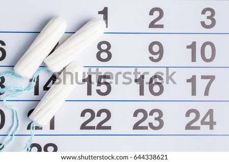 Menstrual calendar with tampons and pads. Menstruation cycle. Hygiene and protection.