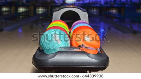 Many multi-colored bowling balls.