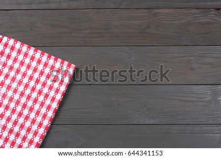 red cloth on dark wooden background with copy space. Top view.