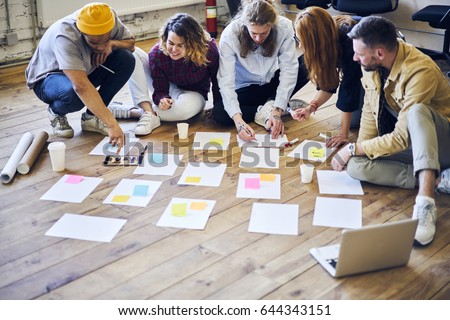 Young creative coworkers making project organizing tasks and processes writing notes on stickers, crew of designers collaborating in office researching and planning strategy for future project

 Royalty-Free Stock Photo #644343151