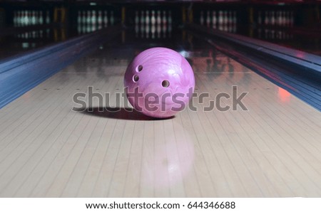 Purple bowling ball on the track. Active leisure. Sport game.