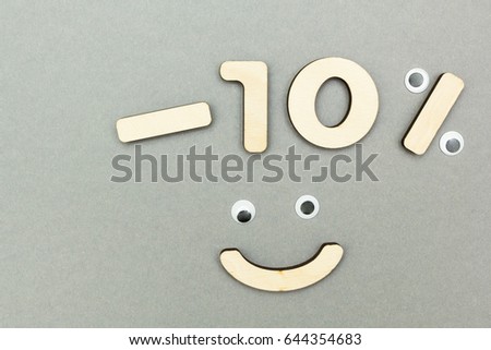 -10% of the wooden figures on a gray paper background. Smiley.