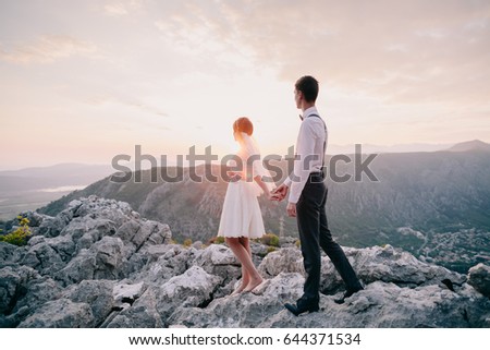 honeymoon wedding couple travel back view. Sunset in mountains