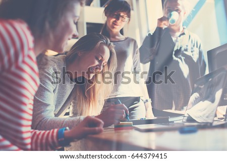 Group of young business people working together in big coworking office. Marketing department discussing product plan. New startup company. Windows reflection effect Royalty-Free Stock Photo #644379415