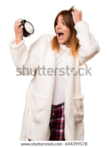 Young woman in dressing gown holding vintage clock