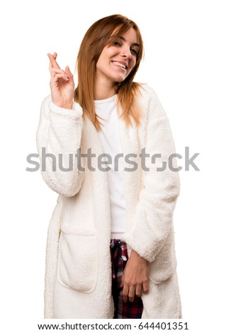 Young woman in dressing gown with her fingers crossing