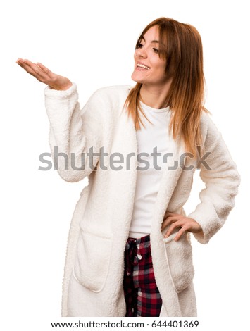Young woman in dressing gown holding something
