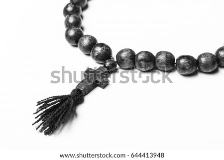 Rosary and a cross on a light gray background