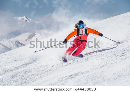 Female skier on a slope in the mountains Royalty-Free Stock Photo #644438050