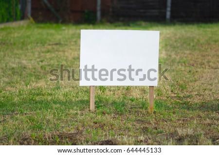 Empty signboard on a piece of ground