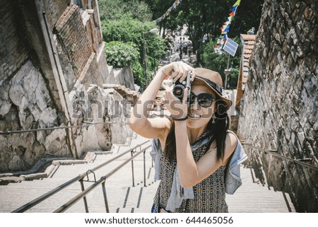 A photographer hipster girl enjoy and take landscape photography.
