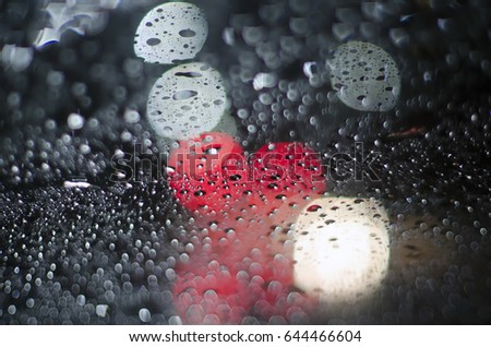 Bad visibility when drunken drive in rainy night, blind vision concept, blurred abstract bokeh from spot of light as background