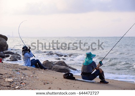 fishing on beach at phala beach rayong thailand  sunset background