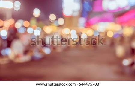 Abstract Blurred image of Night market on street with bokeh for background usage . (vintage tone)