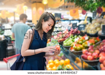 Beautiful women shopping vegetables and fruits in supermarket Royalty-Free Stock Photo #644484067