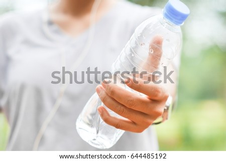 Hand hold a water bottle Royalty-Free Stock Photo #644485192