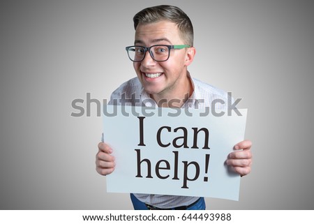 Funny laughing guy (men, student, businessman) of european appearance in casual clothes and glasses is holding a white sheet of paper with text I can help