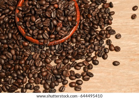 Roasted coffee beans and wooden container with copy space.Heart shape
