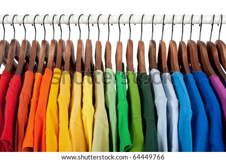 Rainbow colors. Choice of casual clothes on wooden hangers, isolated on white. Royalty-Free Stock Photo #64449766