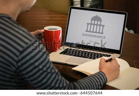 GOVERNANCE and building, Authority Computing Computer Laptop with screen on table Silhouette and filter sun