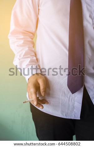 Man hand holding a cigarette 