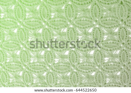 Image texture background, decorative lace with pattern.  green vintage lace background. Green lace on white spandex background, macro view. Ornamental round lace
