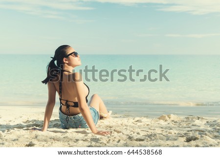 Young fashion woman relax on the beach. 