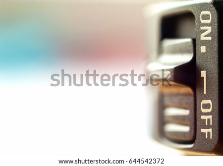Close-up of little On/Off switch with soft blurred background
