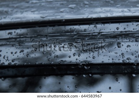 Raindrop on cover mirror of car in rainy season 