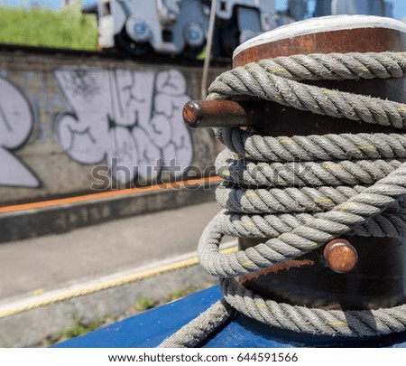 Bollard in Port with a rope and Water