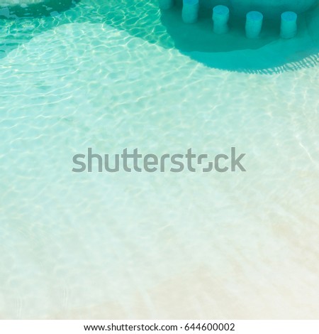 Large swimming pool with seats underwater at a luxury tropical hotel resort in top view