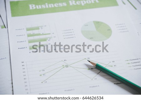 Many charts and graphs with pencil. Reflection light and flare. Concept image of data gathering and statistical working.
