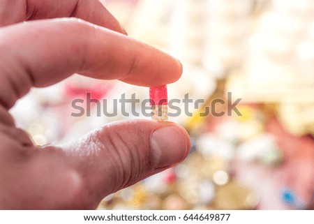 pills in male hand above blister. close up