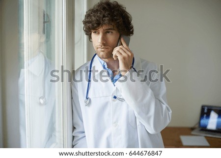 Cropped shot of a young male doctor talking on a cellphone in his office.