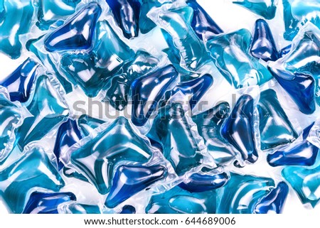 Blue washing capsules on white background, close up, abstract color background