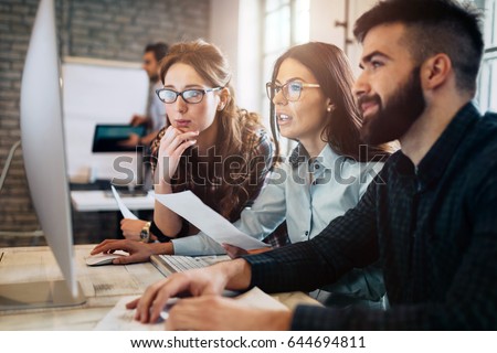 Company employees working in software development and designer office
