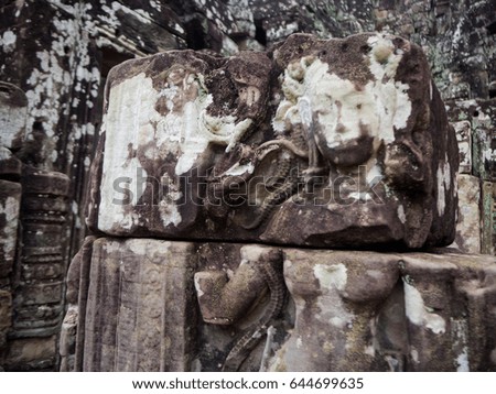 Enigmatic giant stone faces of ancient Bayon temple in Angkor Thom, Siem Reap, Cambodia.