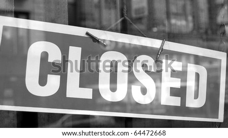 Closed sign in a shop showroom with reflections - (16:9 black and white)
