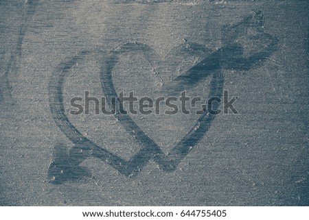 arrows of hearts on dusty wooden floor.