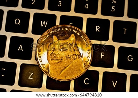 Cryptocurrency physical gold dogecoin money. Royalty-Free Stock Photo #644794810