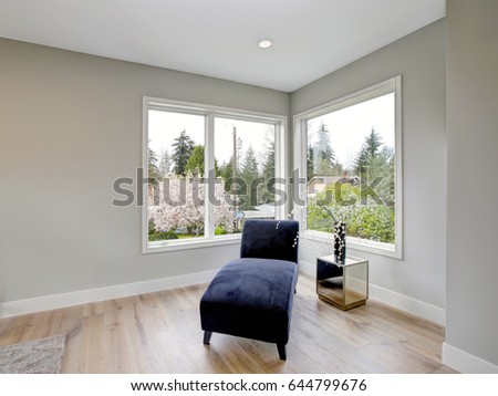 Bedroom reading nook featuring a blue chaise lounge. Northwest, USA