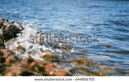 sea with waves and ripples with reflections and refraction of the light rays illuminated by the sun
