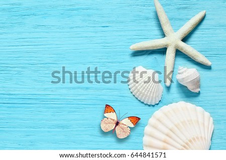 Summer sea background - shells, star on a wooden blue background.